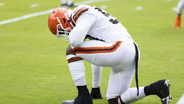 Aug 10, 2024; Cleveland, Ohio, USA; Cleveland Browns defensive end Ogbo Okoronkwo (54) kneels before the game against the Green Bay Packers at Cleveland Browns Stadium. Mandatory Credit: Scott Galvin-Imagn Images