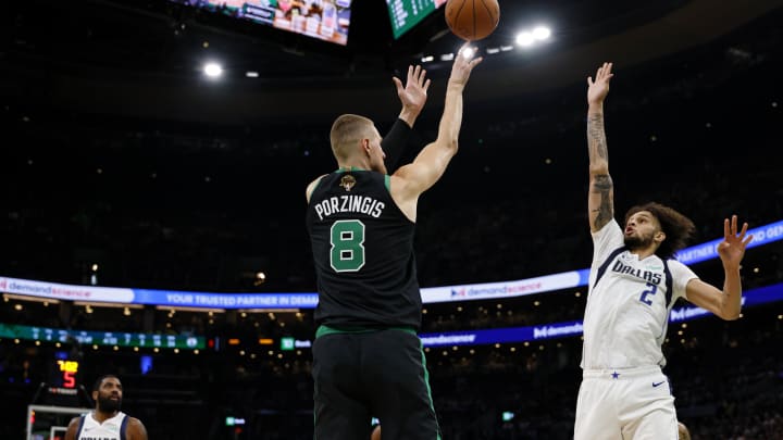 Jun 9, 2024; Boston, Massachusetts, USA; Boston Celtics center Kristaps Porzingis (8) shoots the ball against Dallas Mavericks center Dereck Lively II (2) during the third quarter in game two of the 2024 NBA Finals at TD Garden. Mandatory Credit: Peter Casey-USA TODAY Sports