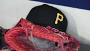 Jun 23, 2025; Milwaukee, Wisconsin, USA; against the Pittsburgh Pirates hat and glove in the dugout before a game against the Milwaukee Brewers at American Family Field. Mandatory Credit: Michael McLoone-Imagn Images