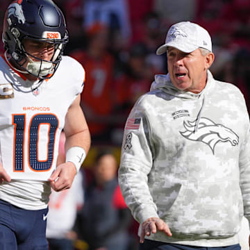Nov 10, 2024; Kansas City, Missouri, USA; Denver Broncos quarterback Bo Nix (10) talks with head coach Sean Peyton   against the Kansas City Chiefs prior to a game at GEHA Field at Arrowhead Stadium. Mandatory Credit: Denny Medley-Imagn Images