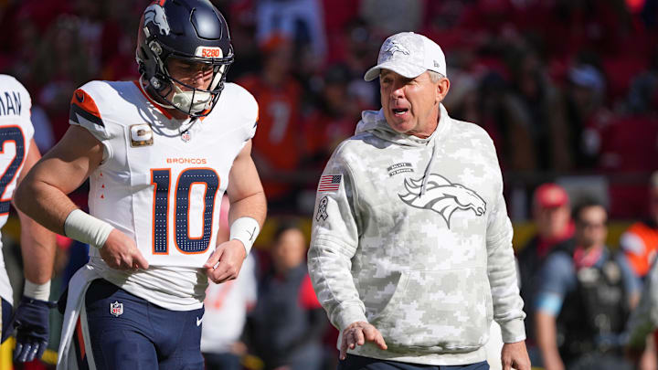 Nov 10, 2024; Kansas City, Missouri, USA; Denver Broncos quarterback Bo Nix (10) talks with head coach Sean Peyton   against the Kansas City Chiefs prior to a game at GEHA Field at Arrowhead Stadium. Mandatory Credit: Denny Medley-Imagn Images