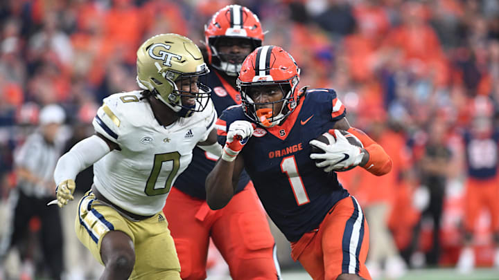 Sep 7, 2024; Syracuse, New York, USA; Syracuse Orange running back LeQuint Allen (1) prepares for contact by Georgia Tech Yellow Jackets linebacker Trenilyas Tatum (0) in the fourth quarter at the JMA Wireless Dome. Mandatory Credit: Mark Konezny-Imagn Images