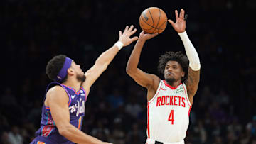 Feb 29, 2024; Phoenix, Arizona, USA; Houston Rockets guard Jalen Green (4) shoots over Phoenix Suns guard Devin Booker (1) during the first half at Footprint Center. Mandatory Credit: Joe Camporeale-Imagn Images