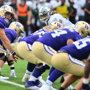 Huskies quarterback Will Rogers (7) prepares to take a first-half snap against Eastern Michigan. 