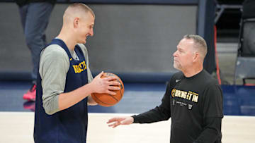 May 31, 2023; Denver, CO, USA; Denver Nuggets center Nikola Jokic (15) talks with head coach Michael Malone during a practice session on media day before the 2023 NBA Finals at Ball Arena. Mandatory Credit: Kyle Terada-Imagn Images