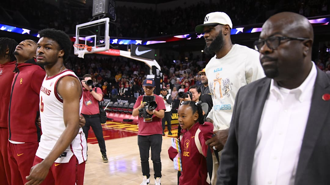 Dec 10, 2023; Los Angeles, California, USA; LeBron James was to his curtsied seats as his son USC Trojans guard Bronny James (6) sands with teammates before the start of a game against the Long Beach State 49ers at Galen Center. Mandatory Credit: Robert Hanashiro-USA TODAY Sports