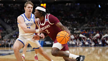 Mar 21, 2025; Milwaukee, WI, USA; Troy Trojans guard Marcus Rigsby Jr. (2) drives to the hoop past Kentucky Wildcats guard Travis Perry (11) during the first half at Fiserv Forum. Mandatory Credit: Jeff Hanisch-Imagn Images