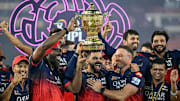 RCB legends Kohli, Gayle, and de Villiers celebrating the moment they dreamed of for 18 years.