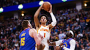 Apr 6, 2024; Denver, Colorado, USA; Atlanta Hawks forward Jalen Johnson (1) shoots over Denver Nuggets center Nikola Jokic (15) and guard Reggie Jackson (7) in the second half at Ball Arena. Mandatory Credit: Michael Ciaglo-Imagn Images