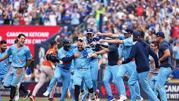 Sep 13, 2025; Toronto, Ontario, CAN; Toronto Blue Jays catcher Alejandro Kirk (30) is swarmed by his teammates after sacrificing in the winning run against the Baltimore Orioles at the end of the ninth inning at Rogers Centre. Mandatory Credit: Nick Turchiaro-Imagn Images