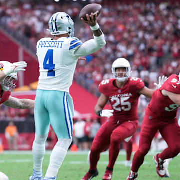 Dallas Cowboys quarterback Dak Prescott is hit by Arizona Cardinals linebacker Dennis Gardeck as he throws.