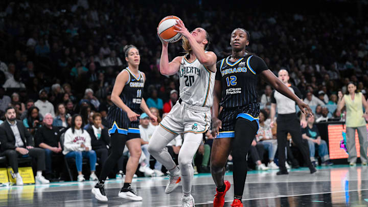 Aug 21, 2025; Brooklyn, New York, USA; New York Liberty guard Sabrina Ionescu (20) drives past Chicago Sky forward Michaela Onyenwere (12) during the second half at Barclays Center. Mandatory Credit: John Jones-Imagn Images