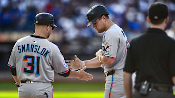 Aug 30, 2025; New York City, New York, USA; Miami Marlins outfielder Jakob Marsee (87) is greeted by first base coach Tyler Smarslok (31) after hitting a RBI single against the New York Mets during the third inning at Citi Field.