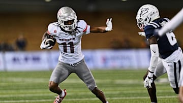Former UNLV Rebels wide receiver Ricky White III (11) runs with the ball against the Utah State Aggies at Merlin Olsen Field at Maverik Stadium. 