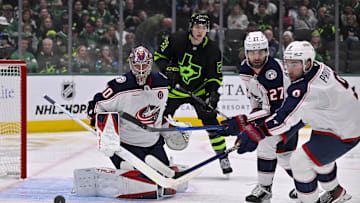 Feb 2, 2025; Dallas, Texas, USA; Columbus Blue Jackets goaltender Elvis Merzlikins (90) and center Zachary Aston-Reese (27) and Dallas Stars left wing Jason Robertson (21) in action during the game between the Dallas Stars and the Columbus Blue Jackets at American Airlines Center. Mandatory Credit: Jerome Miron-Imagn Images