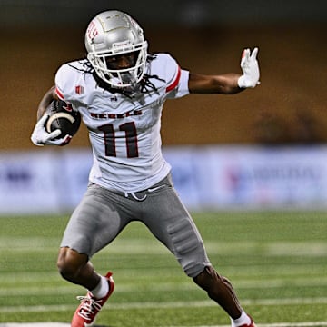 Oct 11, 2024; Logan, Utah, USA;  UNLV Rebels wide receiver Ricky White III (11) runs with the ball against the Utah State Aggies at Merlin Olsen Field at Maverik Stadium. Mandatory Credit: Jamie Sabau-Imagn Images