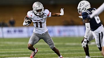 Oct 11, 2024; Logan, Utah, USA;  UNLV Rebels wide receiver Ricky White III (11) runs with the ball against the Utah State Aggies at Merlin Olsen Field at Maverik Stadium. Mandatory Credit: Jamie Sabau-Imagn Images