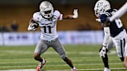 UNLV Rebels wide receiver Ricky White III (11) runs with the ball against the Utah State Aggies at Merlin Olsen Field at Maverik Stadium. Mandatory Credit: Jamie Sabau-Imagn Images