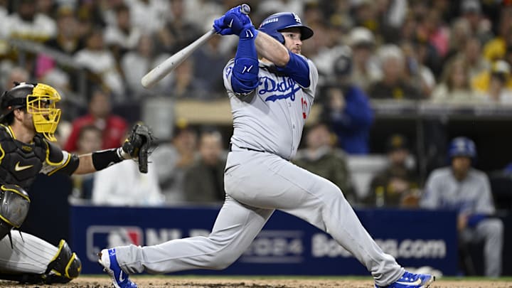 Oct 9, 2024; San Diego, California, USA; Los Angeles Dodgers third baseman Max Muncy (13) hits a double in the third inning against the San Diego Padres during game four of the NLDS for the 2024 MLB Playoffs at Petco Park. Mandatory Credit: Denis Poroy-Imagn Images Oct 9, 2024; San Diego, California, USA; Los Angeles Dodgers third baseman Max Muncy (13) hits a double in the third inning against the San Diego Padres during game four of the NLDS for the 2024 MLB Playoffs at Petco Park. Mandatory Credit: Denis Poroy-Imagn Images