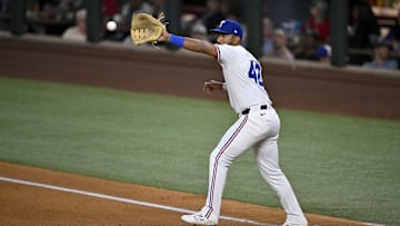 Apr 15, 2025; Arlington, Texas, USA; Texas Rangers first baseman Ezequiel Duran fields a throw to first base during the fifth inning against the Los Angeles Angels at Globe Life Field. All MLB players will be wearing the number 42 on Jackie Robinson Day to commemorate Robinson making his major league debut in 1947. Mandatory Credit: Jerome Miron-Imagn Images
