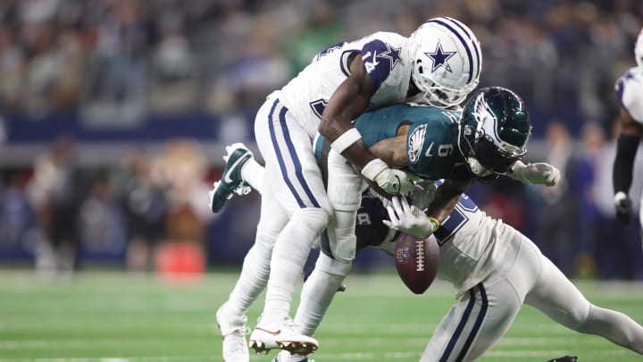 Dec 10, 2023; Arlington, Texas, USA; Philadelphia Eagles wide receiver DeVonta Smith (6) fumbles the ball after being hit by Dallas Cowboys safety Markquese Bell (14) in the fourth quarter at AT&T Stadium. Mandatory Credit: Tim Heitman-USA TODAY Sports