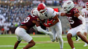 Sep 21, 2024; Blacksburg, Virginia, USA; Rutgers Scarlet Knights tight end Kenny Fletcher (12) runs for the end zone against Virginia Tech Hokies linebacker Caleb Woodson (25) and safety Mose Phillips III (18) during the third quarter at Lane Stadium. Mandatory Credit: Peter Casey-Imagn Images