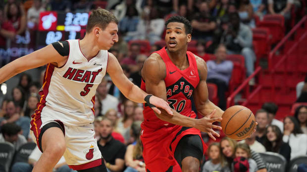 Apr 12, 2024; Miami, Florida, USA;  Toronto Raptors guard Ochai Agbaji (30) brings the ball up the court as Miami Heat forwar