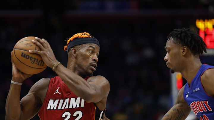 Dec 16, 2024; Detroit, Michigan, USA;  Miami Heat forward Jimmy Butler (22) controls the ball as Detroit Pistons forward Ronald Holland II (00) defends in the first half at Little Caesars Arena. Mandatory Credit: Rick Osentoski-Imagn Images
