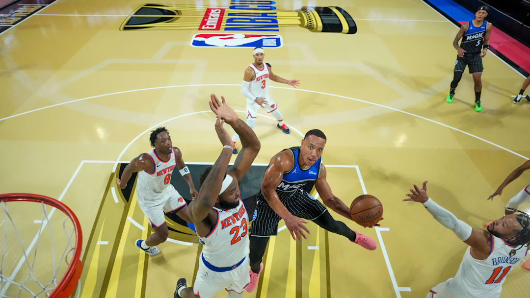 Dec 13, 2025; Las Vegas, Nevada, USA; Orlando Magic guard Desmond Bane (3) drives to the basket on New York Knicks center Mitchell Robinson (23) and guard Jalen Brunson (11) during a game at T-Mobile Arena. Mandatory Credit: Kirby Lee-Imagn Images