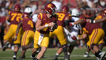 Oct 12, 2024; Los Angeles, California, USA;  USC Trojans quarterback Miller Moss (7) looks to throw a pass in the second half against the Penn State Nittany Lions at United Airlines Field at Los Angeles Memorial Coliseum. Mandatory Credit: Jayne Kamin-Oncea-Imagn Images