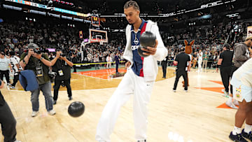 Apr 13, 2025; San Antonio, Texas, USA; San Antonio Spurs center Victor Wembanyama (1) plays around with a ball in celebration of Fan Appreciation Day after a victory over the Toronto Raptors at Frost Bank Center. Mandatory Credit: Scott Wachter-Imagn Images