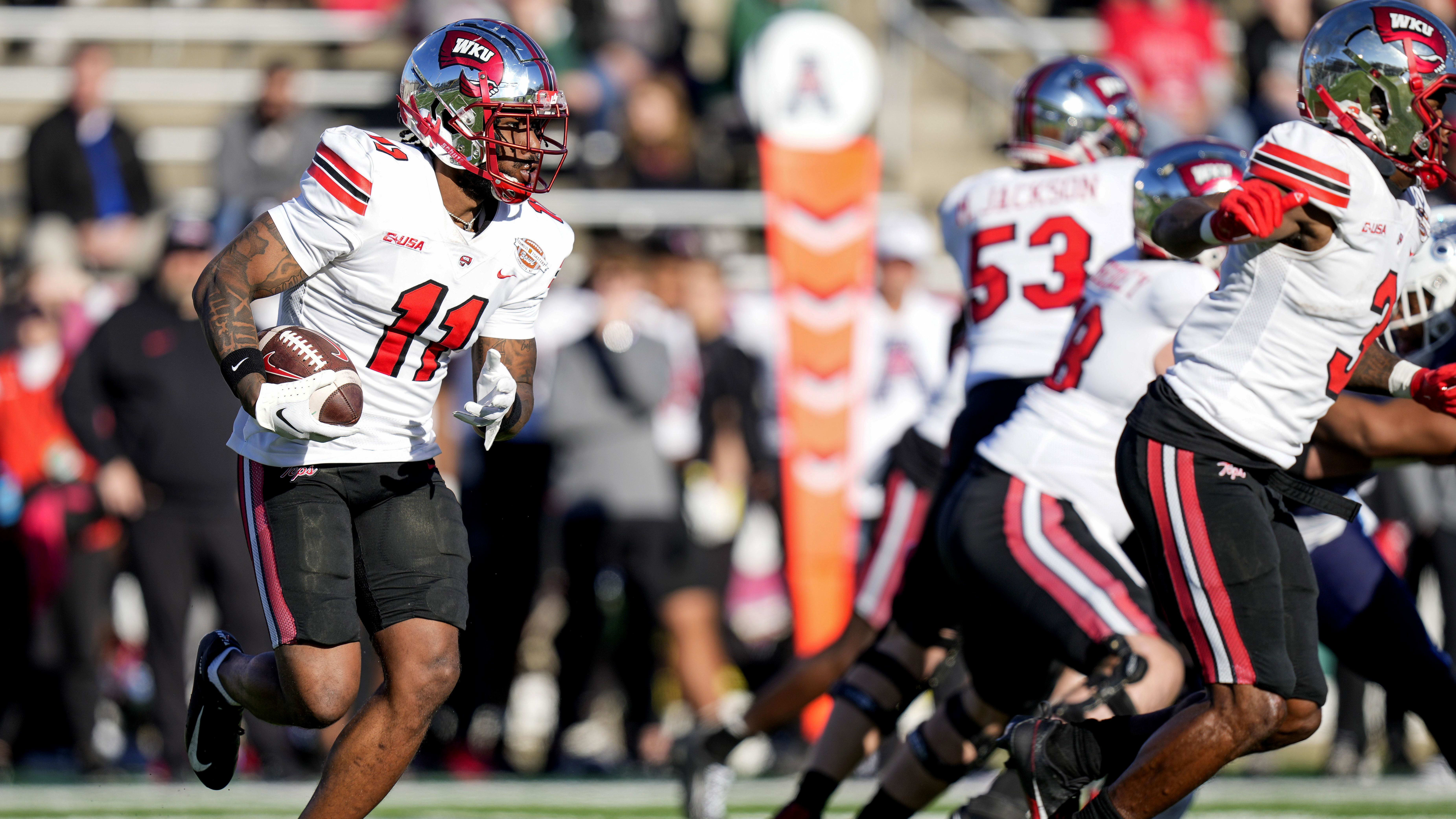 Western Kentucky Hilltoppers wide receiver Malachi Corley (11) runs the ball against the Old Dominion Monarchs.
