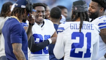 Dallas Cowboys cornerback DaRon Bland (26) smiles with teammates defensive tackle Johnathan Hankins (95) and former cornerback Stephon Gilmore (21) as the final seconds tick away against the Carolina Panthers during the second half at Bank of America Stadium.