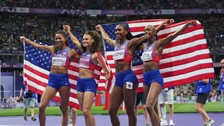 Aug 10, 2024; Saint-Denis, FRANCE;  Alexis Holmes (USA) celebrates with Sydney McLaughlin-Levrone (USA), Shamier Little (USA) and Gabrielle Thomas (USA) after winning the women's 4x400m final during the Paris 2024 Olympic Summer Games at Stade de France. Mandatory Credit: Kirby Lee-USA TODAY Sports