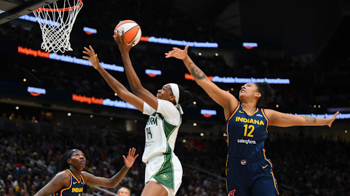 Aug 3, 2025; Seattle, Washington, USA; Seattle Storm center Dominique Malonga (14) shoots the ball while guarded by Indiana Fever forward Damiris Dantas (12) during the second half at Climate Pledge Arena. 