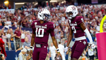 Sep 28, 2024; Arlington, Texas, USA; Texas A&M Aggies quarterback Marcel Reed (10) celebrates with Texas A&M Aggies wide receiver Jahdae Walker (9) after scoring a touchdown during the first half against the Arkansas Razorbacks at AT&T Stadium. Mandatory Credit: Kevin Jairaj-Imagn Images