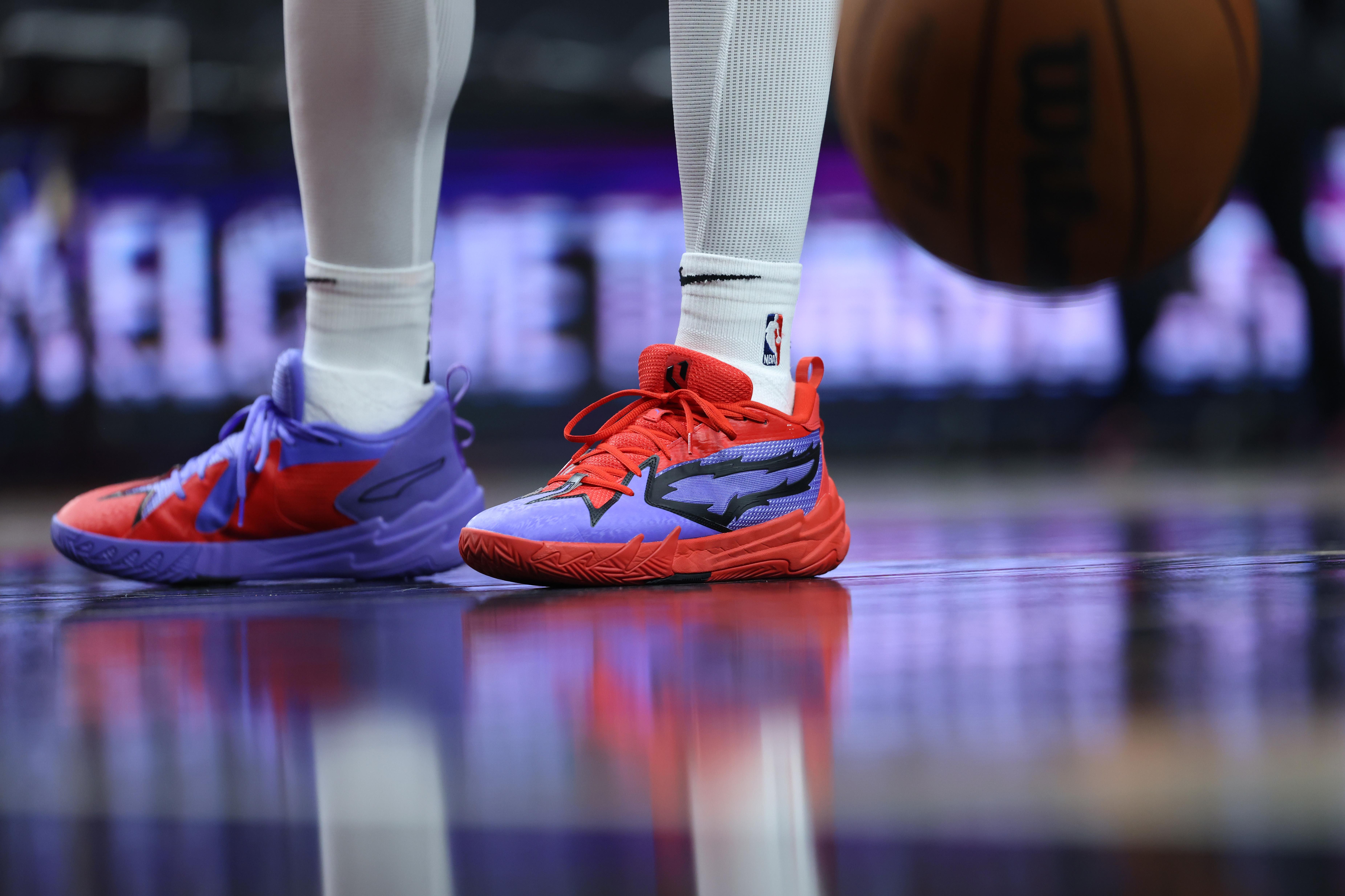 Portland Trail Blazers guard Scoot Henderson's red and blue PUMA sneakers.