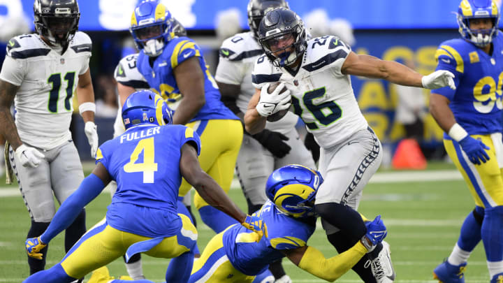 Nov 19, 2023; Inglewood, California, USA;  Seattle Seahawks running back Zach Charbonnet (26) runs against Los Angeles Rams safety Quentin Lake (37) and safety Jordan Fuller (4) in the first half at SoFi Stadium. Mandatory Credit: Robert Hanashiro-USA TODAY Sports