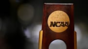 A view of the NCAA logo and trophy before the 2025 women's national gymnastics championship at Dickies Arena.