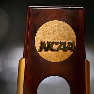 A view of the NCAA logo and trophy before the 2025 women's national gymnastics championship at Dickies Arena.