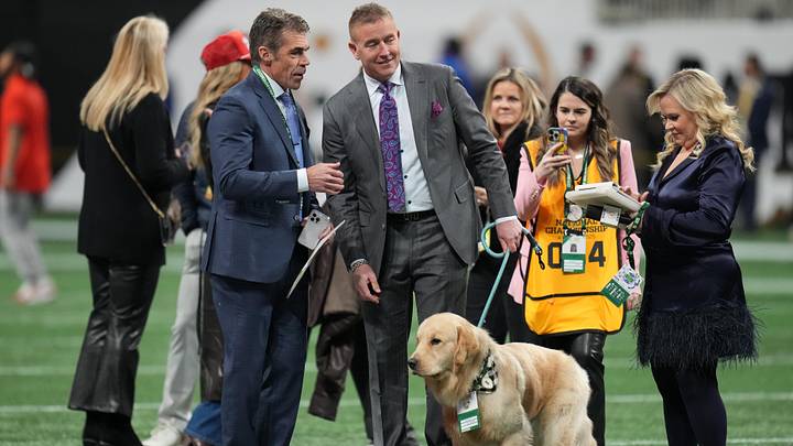 Jan 20, 2025; Atlanta, GA, USA; ESPN broadcast team of Chris Fowler, Kirk Herbstreit and Holly Rowe with golden retriever Peter before the CFP National Championship college football game between the Notre Dame Fighting Irish and the Ohio State Buckeyes at Mercedes-Benz Stadium. Mandatory Credit: Kirby Lee-Imagn Images