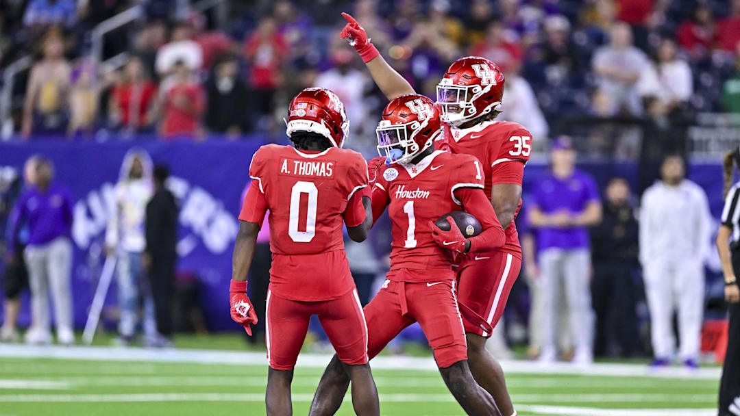 Dec 27, 2025; Houston, TX, USA; Houston Cougars defensive back Blake Thompson (0) and defensive back Latrell McCutchin Sr. (1) reacts during the second half against the Louisiana State Tigers at NRG Stadium. Mandatory Credit: Maria Lysaker-Imagn Images 