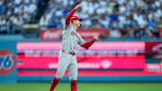 Cincinnati Reds right fielder Austin Hays (12) celebrates an RBI double in the first inning of the MLB National League Wild Card Game 2 between the Los Angeles Dodgers and the Cincinnati Reds at Dodger Stadium in Los Angeles on Wednesday, Oct. 1, 2025. The Reds were eliminated from the postseason with an 8-4 loss to the reining World Series Champions La Dodgers.