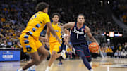 UConn guard Solomon Ball drives for the basket against Marquette forward Royce Parham.