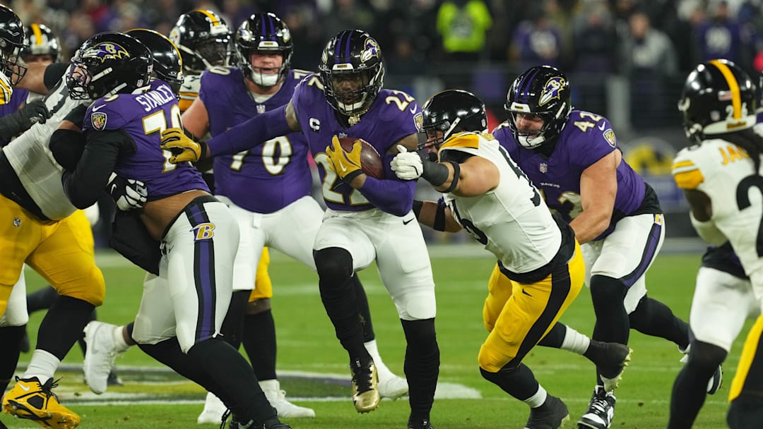 Jan 11, 2025; Baltimore, Maryland, USA; Baltimore Ravens running back Derrick Henry (22) runs against Pittsburgh Steelers linebacker Alex Highsmith (56) in the second quarter in an AFC wild card game at M&T Bank Stadium. Mandatory Credit: Mitch Stringer-Imagn Images