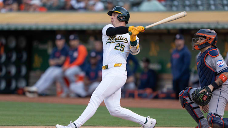 Jul 23, 2024; Oakland, California, USA;  Oakland Athletics outfielder Brent Rooker (25) hits a two-run home run during the first inning against the Houston Astros at Oakland-Alameda County Coliseum. Mandatory Credit: Stan Szeto-USA TODAY Sports