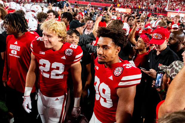 Nebraska Cornhuskers linebacker Maverick Noonan (22) and defensive back Taveon Thompson (39) walk off the field 