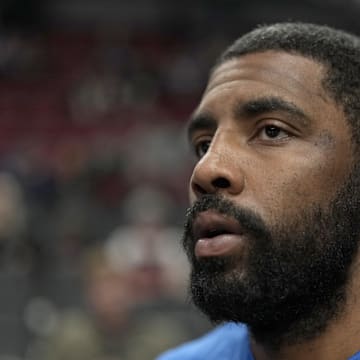 Dec 8, 2023; Portland, Oregon, USA; Dallas Mavericks point guard Kyrie Irving (11) runs to the court for warm ups before the game against the Portland Trail Blazers at Moda Center. Mandatory Credit: Soobum Im-Imagn Images