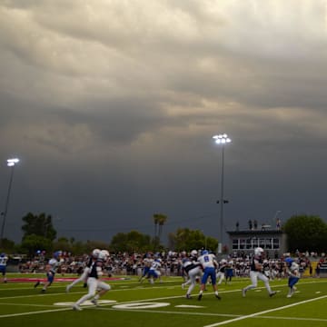 A head football coach in Arizona has been suspended for not reporting an auto accident over the summer.