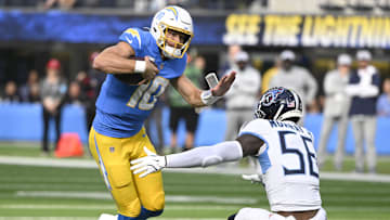 Nov 10, 2024; Inglewood, California, USA; Los Angeles Chargers quarterback Justin Herbert (10) tried to get past Tennessee Titans linebacker Kenneth Murray Jr. (56) during the first quarter at SoFi Stadium. Mandatory Credit: Robert Hanashiro-Imagn Images